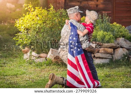 Military man father hugs son. Portrait of happy american family. sunshine
