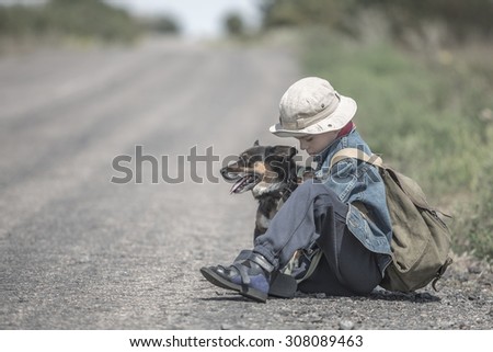 Boy with dog on a trip on road sitting relaxing