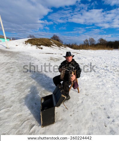 SUZDAL, RUSSIA - March 08, 2015: Winter day in the Russian city Suzdal. One of the most popular from Golden Ring cities. A man playing on accordion