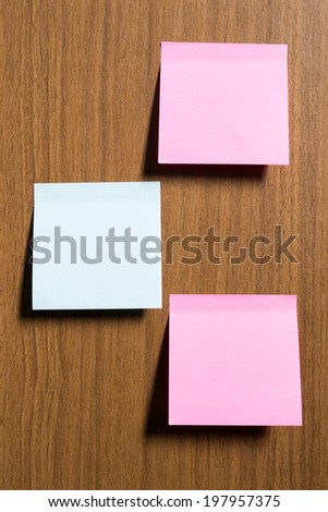 Sticky notes stick on wooden texture