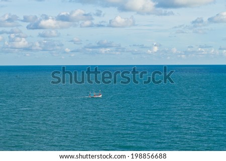Lonely boat in the middle of the sea