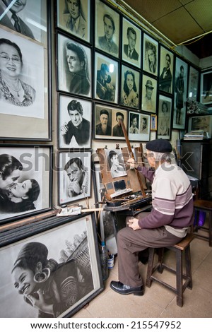 HOI AN, VIETNAM - NOV 11:Old painter drawing in gallery , on Nov 11, 2011. Crafts are a popular job in Hoi An.