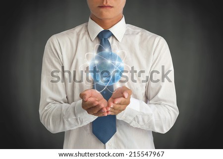 Business man holding the small world in his hands against dark background