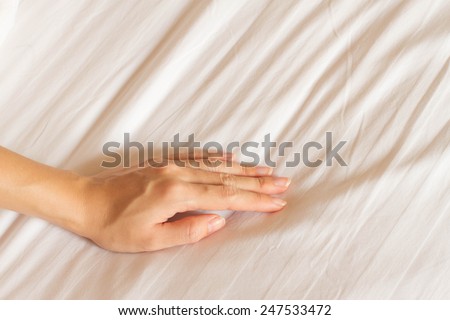 female hand touching and testing bed