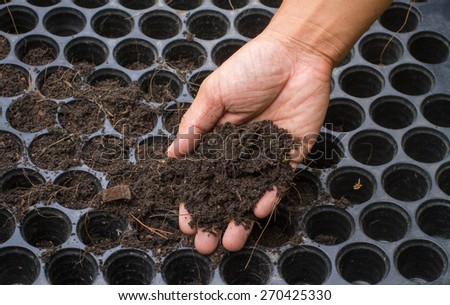 Hand holding soil,Hand dirty with soil
