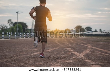 Asian men are siluate jogging at a speed in the evening. Man silhouette running in sunset.