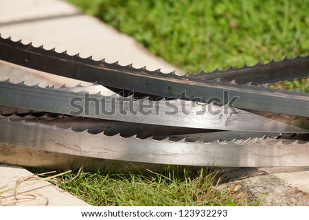 band-saw blades stacked on the ground