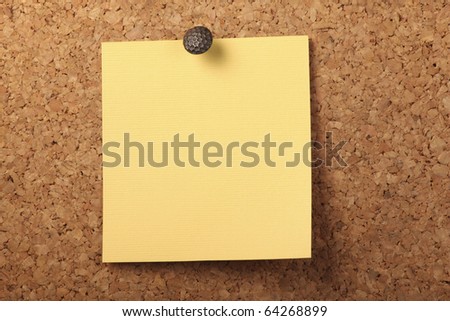 Blank Yellow textured notebook paper Pinned to the cork board.