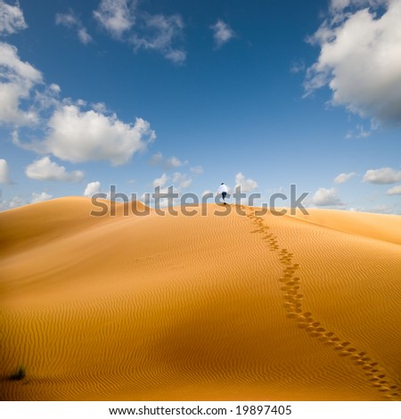 Walking in desert, conceptual; walking away from trouble