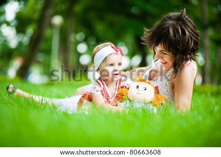 beautiful young mother and her daughter in the park