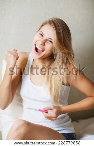 Pregnancy test - happy surprised woman, positive result