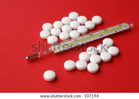 Old fashion quicksilver thermometer with white pills on red background