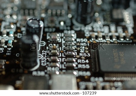 close up of computer board with microchip, resistors and condensators