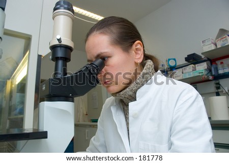 a scientist woman works with microscope in the laboratory