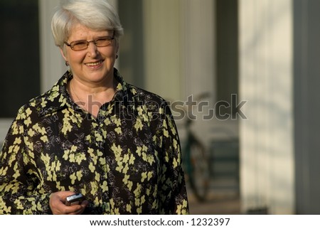 elderly woman outdoors with cell phone