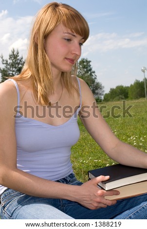 young girl with a book outside