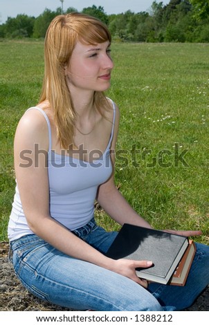 young girl with a book outside