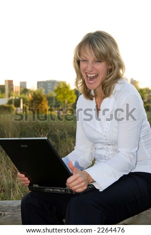 blond pretty woman works with laptop