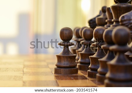 Chess standing on the board with a black pawn made a step forward