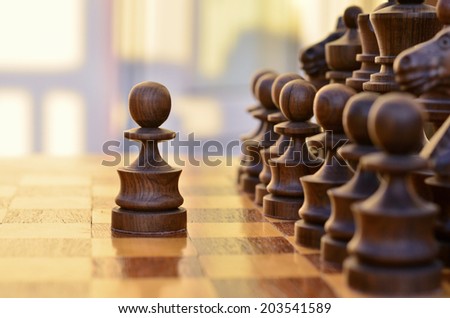Chess standing on the board with a black pawn made a step forward