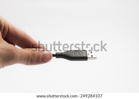 A hand keeping a usb cable
