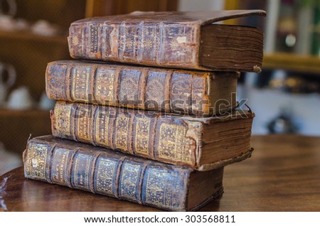 PAU, FRANCE - JULY, 19: A pile of old ancient books in the dark room in Pau, France on 19 July, 2015