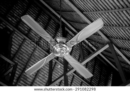 Electric fan on ceiling (by black and white style and focus on blade with trying to make dark ceiling to make clear fan and keep importance on subject)