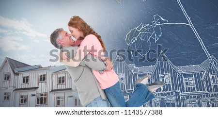 Casual couple hugging each other against nice residence with a blue and white filter
