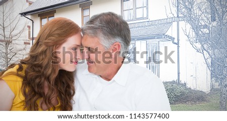 Casual couple smiling at each other against pretty house with a blue and white filter