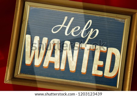 Empty photo frame against vintage help wanted sign