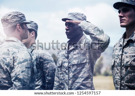 Military trainer giving training to military soldier at boot camp