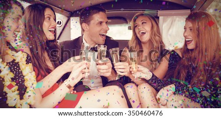 Flying colours against happy friends drinking champagne in limousine