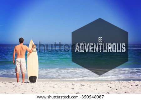 Motivational new years message against man wirth his surfboard on the beach