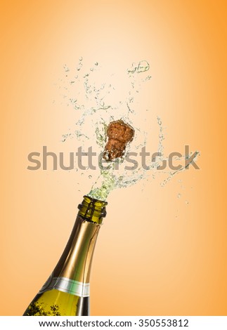 Champagne popping against orange vignette