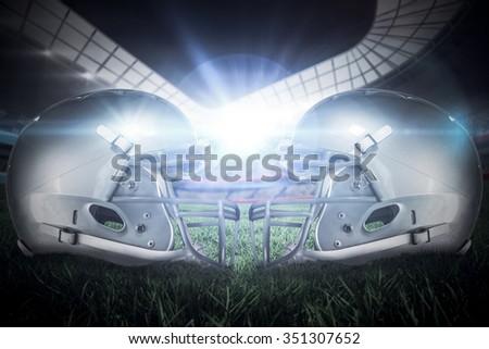 American football helmet against rugby stadium