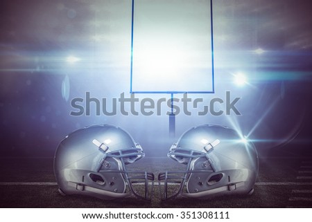 American football helmet against american football arena