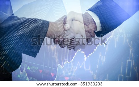 Stocks and shares against composite image of handshake between two business people