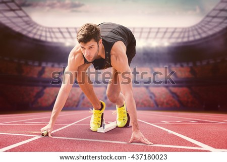 Composite image of sportsman starting to sprint in a stadium