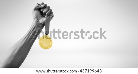 Hand holding a silver medal on white background