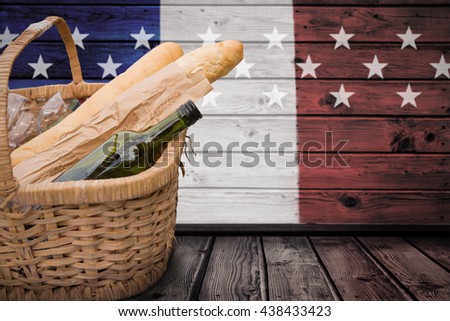 Picnic of wine and baguettes against composite image of usa national flag
