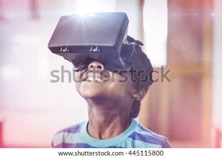 School boy in virtual reality glasses in classroom at school