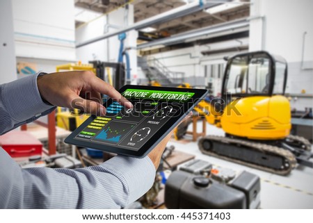 Man using tablet pc against industrial equipments in factory
