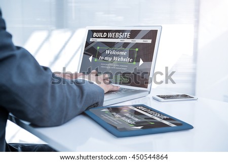 Composite image of build website interface against businessman using his computer