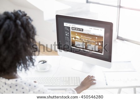 Composite image of build website interface against over the shoulder view of woman using computer