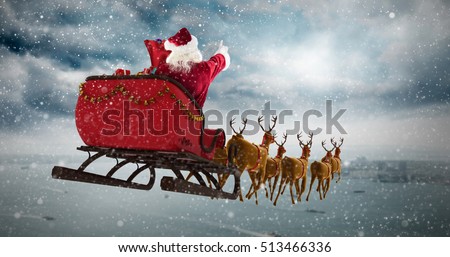 Santa Claus riding on sleigh during Christmas against coastline and city