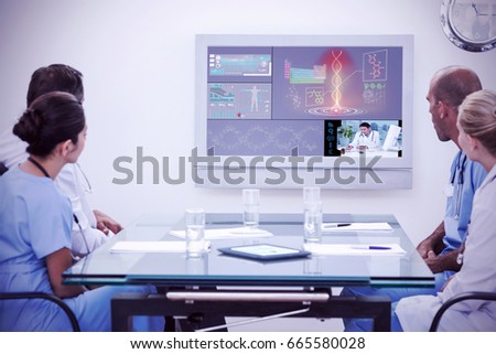 Team of doctors having a meeting against uniformed doctor analyzing human body