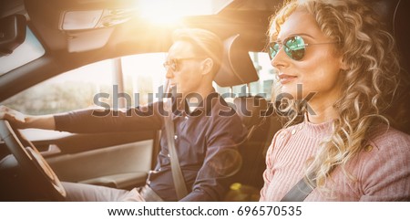 Couple driving car during test drive