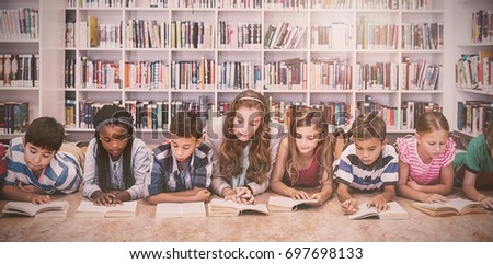 Teacher reading books to her students at school