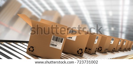 Row of brown boxes on conveyor belt against boxes in illuminated warehouse