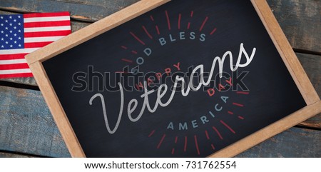 Logo for veterans day in america  against overhead view of chalkboard with american flag